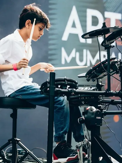 A young drummer completely in his element during a performance at Art Mumbai. We love seeing our students find their rhythm and passion on stage.