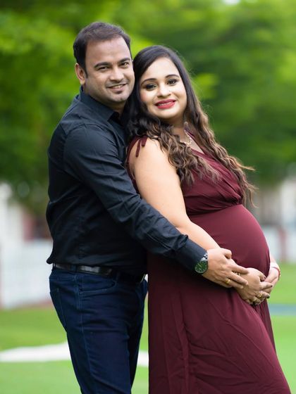 An outdoor portrait of a couple sharing a quiet moment. The natural greenery provides a beautiful, serene backdrop for their connection.