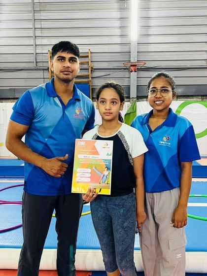 A team of coaches celebrates with two of their students who have earned new certificates.