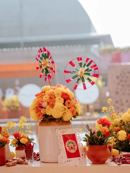 A centerpiece featuring a bouquet of marigolds and handcrafted pinwheels. These details brought a sense of childhood nostalgia and playfulness to the event.