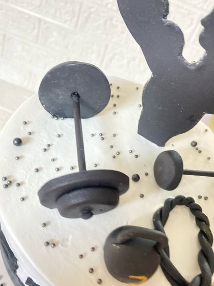 A close-up of the handcrafted fondant gym equipment on our fitness-themed cake.