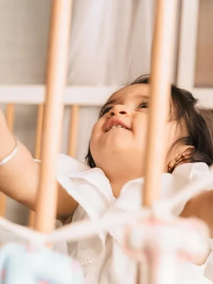 A moment of wonder. Looking up from her crib, this baby's expression is full of curiosity. These are the quiet, beautiful moments that tell the story of your child's world.