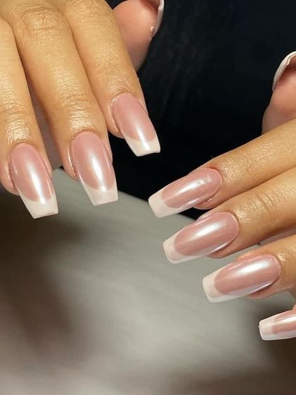 A classic French manicure on square-shaped extensions with a pearlescent finish for an added touch of sophistication.