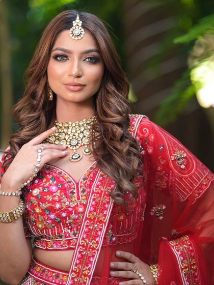 A complete bridal look featuring a heavy, gold-plated Kundan necklace, haath phool, and maang tikka, all available for rent.