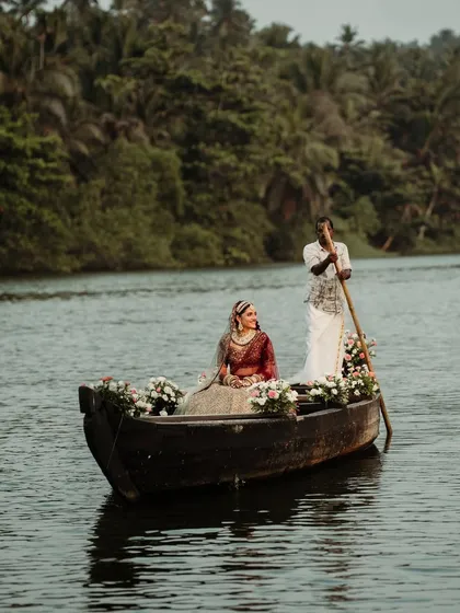 A wider view of the bride's boat entry, showcasing the stunning natural scenery of the Goan backwaters. I help select venues that offer such unique opportunities for unforgettable wedding moments.