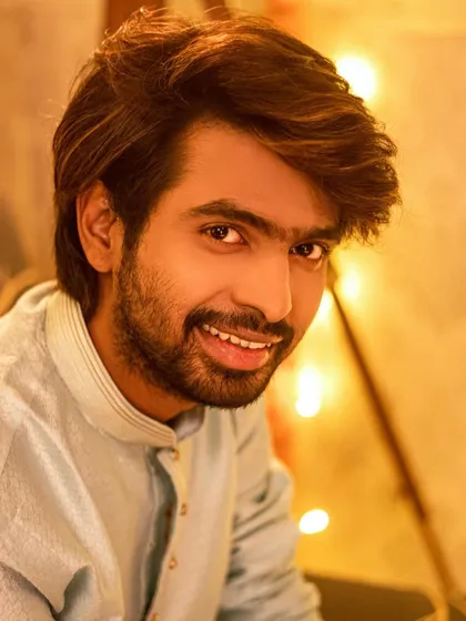 Festive shoots are for everyone! A happy, smiling portrait of Prathamesh Parab, capturing the joyful spirit of Diwali with a backdrop of fairy lights.