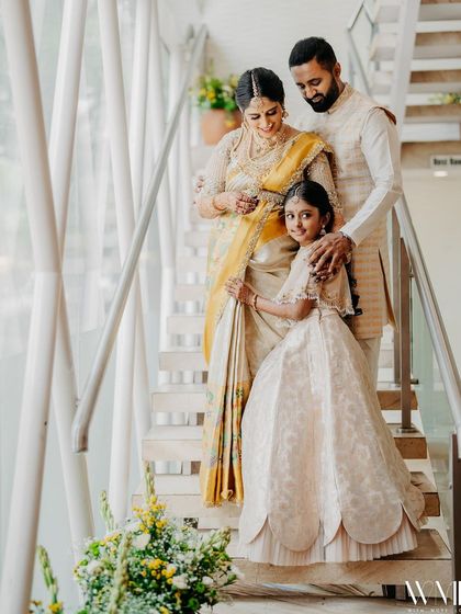 A beautiful family portrait from my baby shower. My husband, daughter, and I are all dressed in coordinated cream and yellow outfits, celebrating the upcoming arrival of our new family member.