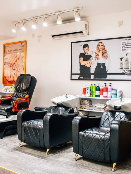 This is our relaxation zone. Our salon features comfortable, dedicated chairs for pedicures and hair washes, ensuring you have a peaceful and enjoyable experience from start to finish.
