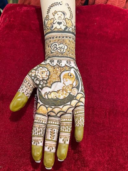 A close-up of the "Boy" hand, featuring a baby sleeping on the moon and a teddy bear wreath.