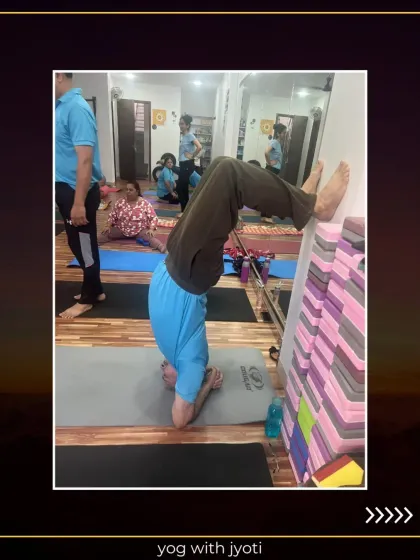 A student uses a stack of yoga blocks against the wall for a supported headstand variation. Props are creative tools that help us adapt poses to our individual needs.