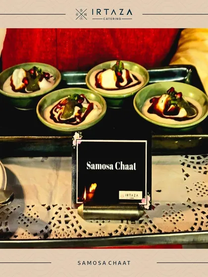 Samosa Chaat served in small ceramic bowls. This classic Indian snack is given a gourmet twist with a beautiful presentation, perfect for any celebration.