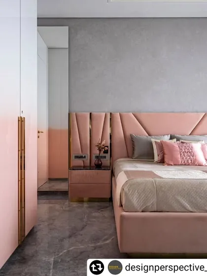 A view of the daughter's bedroom in the 'Fifty Two' apartment, where the pink ombre wardrobes and upholstered bed create a cohesive and stylish look.