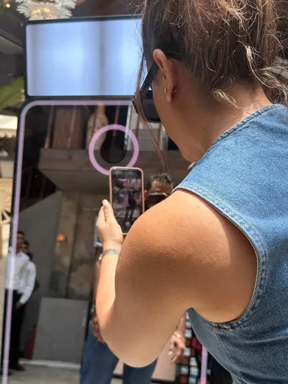A guest's view of the Magic Mirror. The interactive screen guides you through the process, from striking a pose to instantly sharing your photo via QR code.