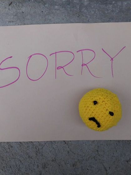A simple note with my handmade sad emoji amigurumi.