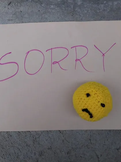 A simple note with my handmade sad emoji amigurumi.
