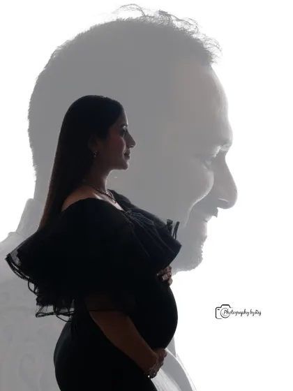A creative double-exposure silhouette, blending a portrait of the mother-to-be with her partner's profile.
