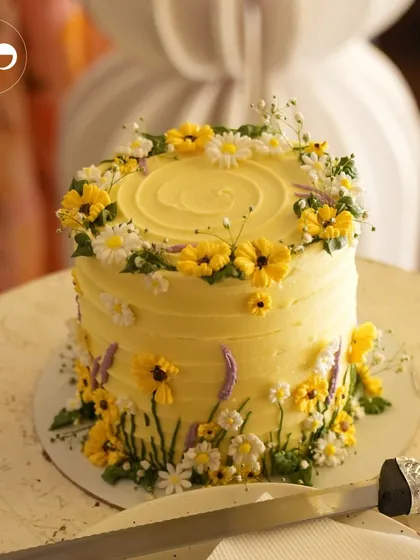 A beautiful yellow cake decorated with delicate, hand-crafted sugar flowers. This was the perfect sweet treat for a 'Baby in Bloom' honeybee-themed shower.