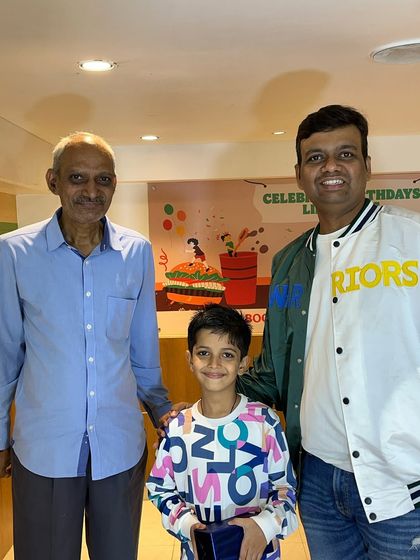 A student with his family after receiving his award at the Abacus prize distribution event. It's a community effort, and I'm grateful for the support of our students' families.