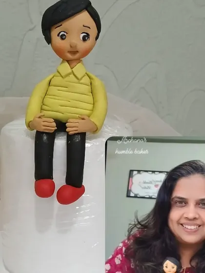 Me with one of my handmade fondant boy figurines.
