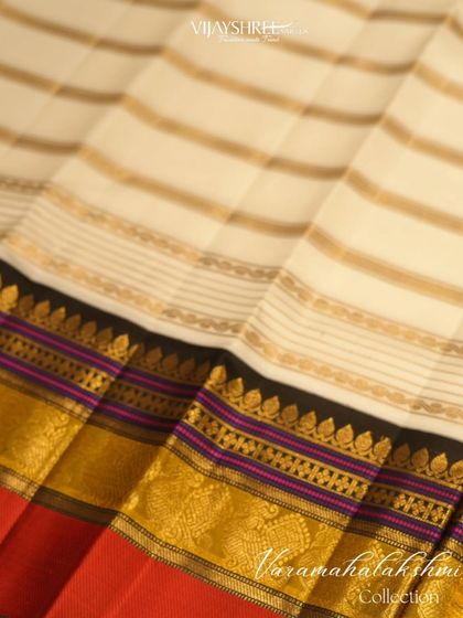 A classic multi-color border on an off-white Kanjivaram, a subtle yet festive choice.