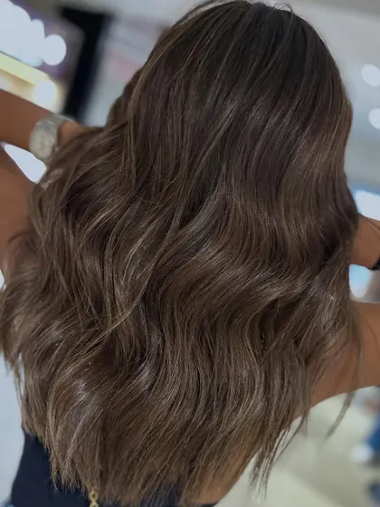 This cool-tone balayage is perfect for a spring or summer refresh. The color gives a modern, chic vibe to her long, healthy hair.