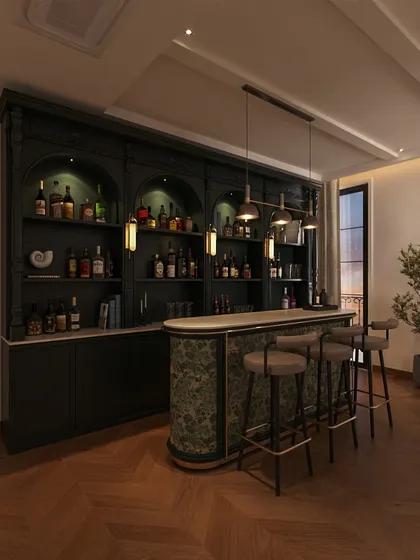 This expansive bar is the heart of the family lounge, designed for entertaining. The rich, dark green finish and neoclassical arched shelving create a statement piece that is both dramatic and luxurious.