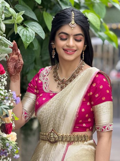 A lovely candid shot of the bride smelling flowers. The natural makeup look is perfect for a daytime event, looking fresh and effortless.