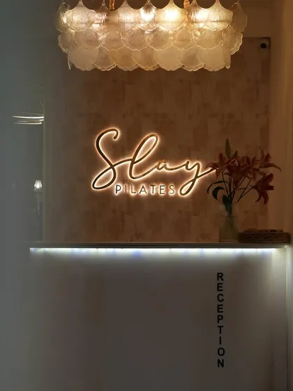 Your journey starts here, at the Slay Pilates reception. I wanted every detail, from the lighting to the flowers, to make you feel welcome.