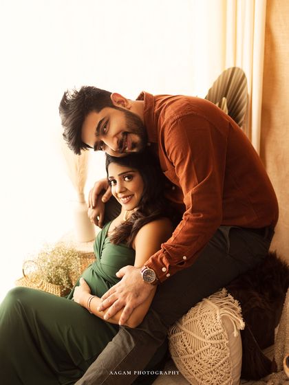 A playful and loving moment between the couple. His embrace from behind is both supportive and sweet.