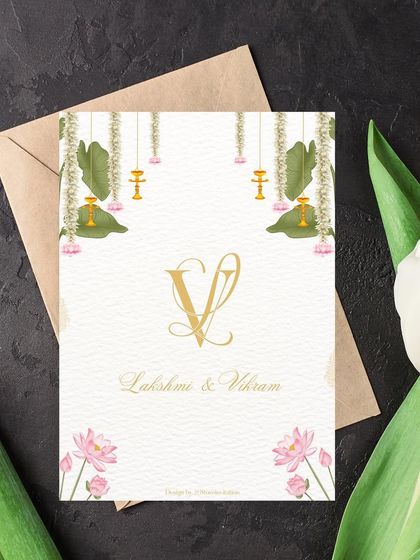 A minimalist design that is purely exquisite. This engagement invitation for Lakshmi and Vikram features their custom monogram with traditional Indian motifs like banana leaves and lotuses for a touch of cultural elegance.
