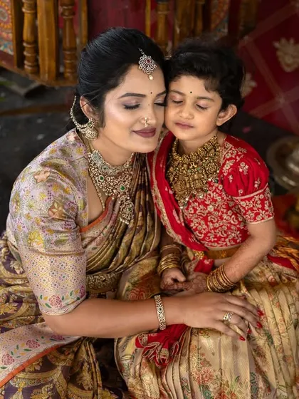 An intimate and emotional photograph of a mother and daughter sharing a tender embrace during a traditional ceremony, surrounded by flowers and blessings.