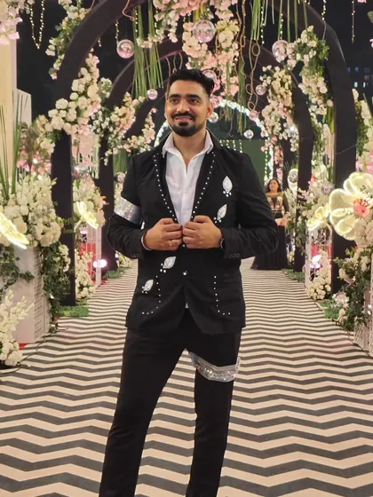 Dressed and ready to bring the energy to a beautiful wedding reception. I believe in looking the part, whether it's a grand, elegant affair or a casual party. This stunning floral archway was the perfect backdrop to kick off a night of fun.