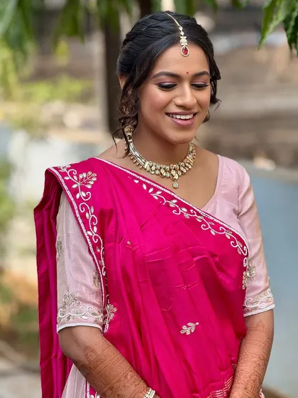 A smiling portrait of the bride during her Path Muhurat. The makeup is soft and glowing, and her happiness is evident.