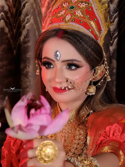 A serene Durga-inspired look, with the model holding a lotus flower, symbolizing purity and divinity.