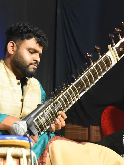 Deep in concentration during a live performance, with a tabla player beside me. This highlights my experience in performing traditional jugalbandi duets.