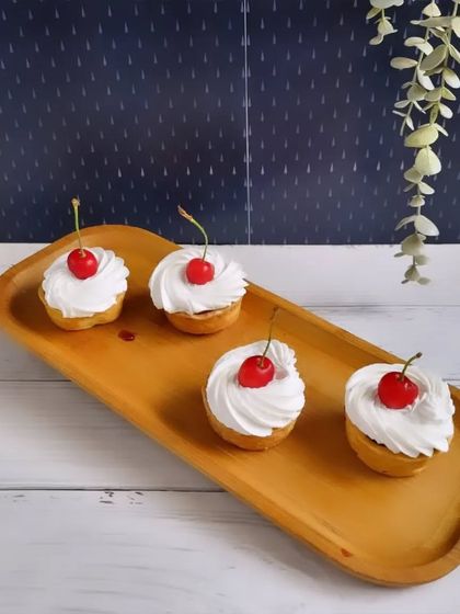 These cherry tarts from our Monsoon Fiesta collection are a classic treat. A simple tart shell is filled with cream and topped with a bright red cherry.