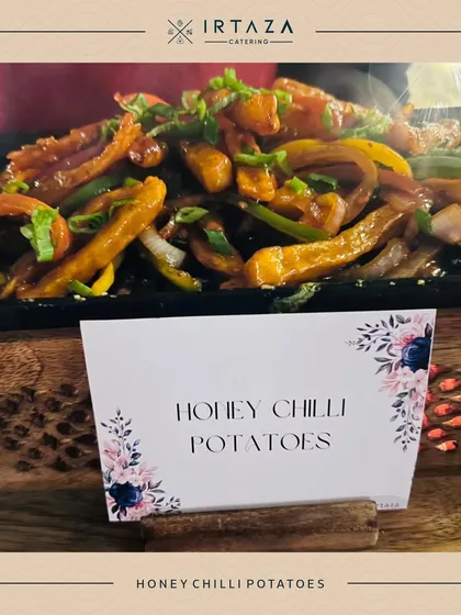 A close-up of my Honey Chilli Potatoes, a classic favorite. The potatoes are crispy, sweet, and spicy, garnished with spring onions for freshness.
