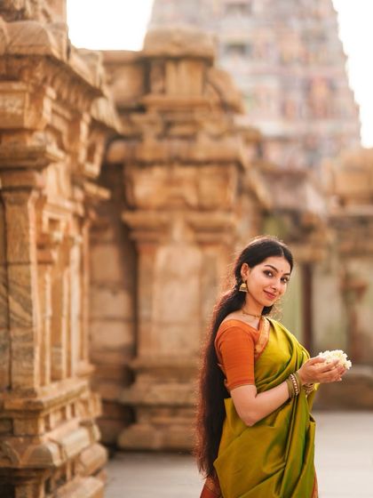 A serene portrait at a heritage temple site. The historical architecture provides a powerful and authentic backdrop for modeling traditional wear and jewelry.