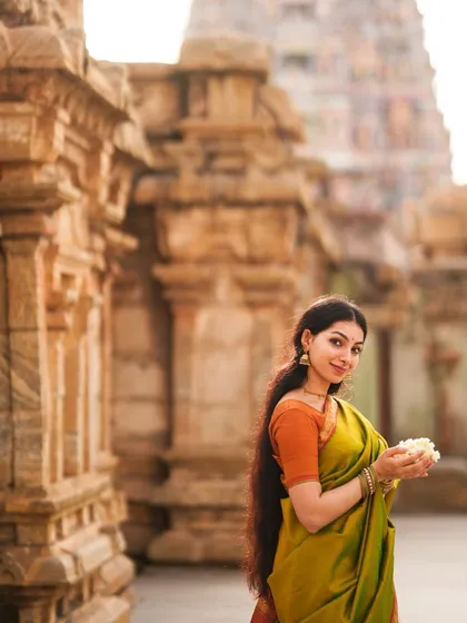A serene portrait at a heritage temple site. The historical architecture provides a powerful and authentic backdrop for modeling traditional wear and jewelry.