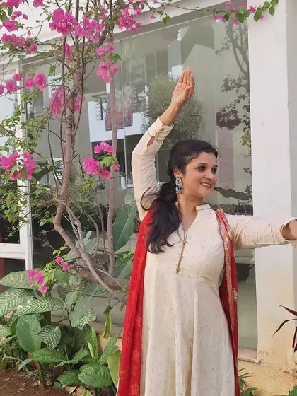 An identical shot showing the full pose amidst the beautiful floral background.