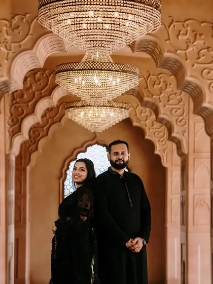 A majestic shot of the couple under the chandeliers. My goal was to create a look for her that was as grand and timeless as the setting.