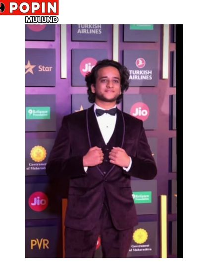 A client looking elegant in a deep maroon velvet tuxedo. The luxurious fabric and classic cut make this a perfect choice for a winter wedding or formal gala.