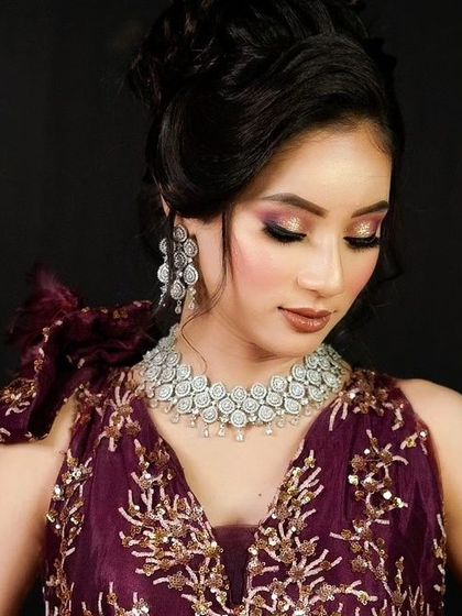 A model wearing a purple gown with a simple yet elegant AD necklace and earrings. This set is perfect for guests or bridesmaids.