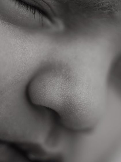 A close-up of a perfect little button nose. These black and white detail shots highlight the delicate textures and features that make your baby unique.
