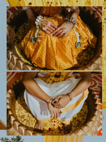 A detailed shot focusing on the bride and groom's hands, adorned with floral jewelry, during the Haldi ritual.