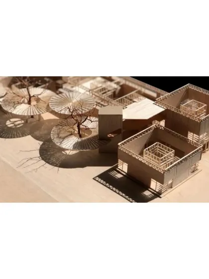 The 'roofs off' view of the model, emphasizing the courtyard-centric design of the school pods.