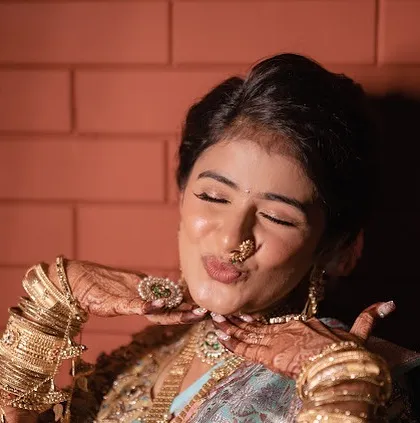 A playful moment with the bride. Her makeup is flawless and radiant, making her look like a movie star.