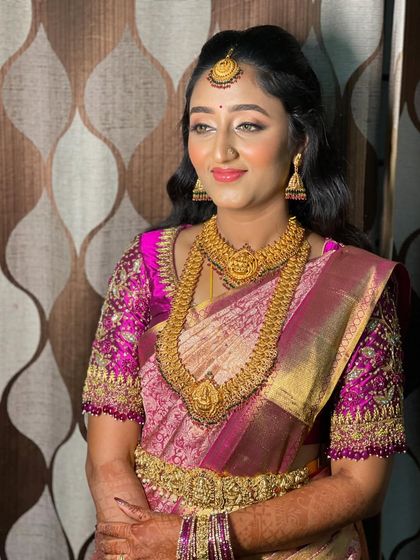 Vidya looking radiant and happy. The half-up hairstyle keeps the hair away from her face while still showing off its length and texture.