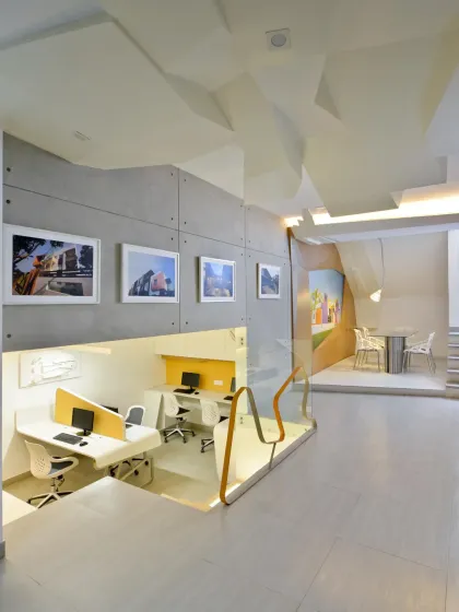 The split-level design of my studio ensures visual connectivity between floors. The lower level, dedicated to junior architects, is visible from above, fostering a sense of an open and collaborative environment.