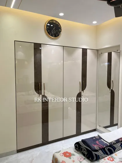 A stylish two-tone wardrobe with a glossy finish and elegant handles. The attached full-length mirror is a practical addition that also helps make the room feel more spacious.